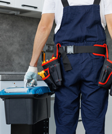 Technician repairing residential garage door in Ontario – PrimeCore Services