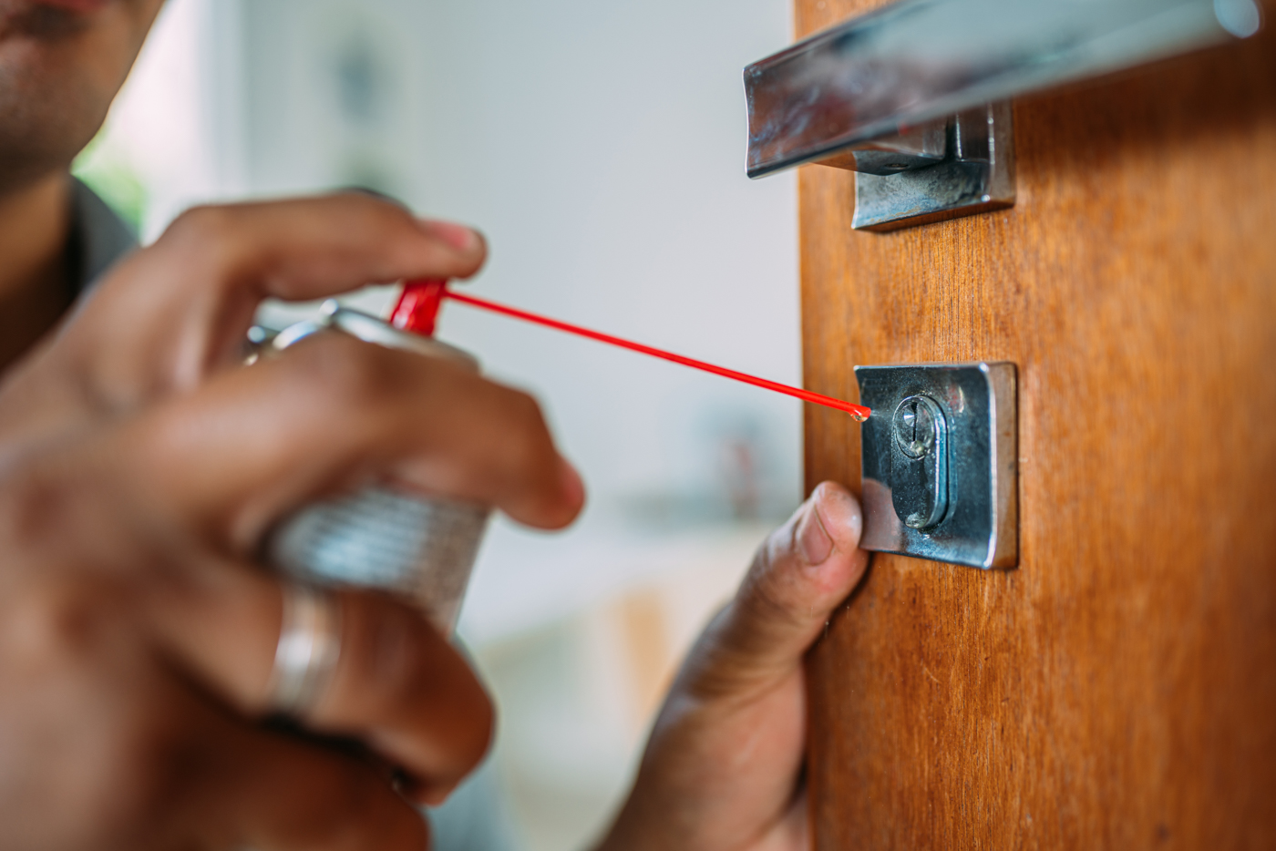 Locksmith installing modern door lock mechanism