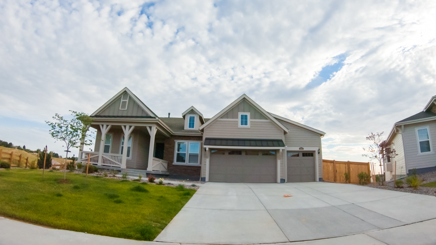 Modern green garage door on Canadian home driveway