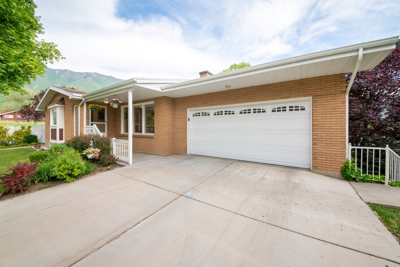 Modern white residential garage door with window inserts