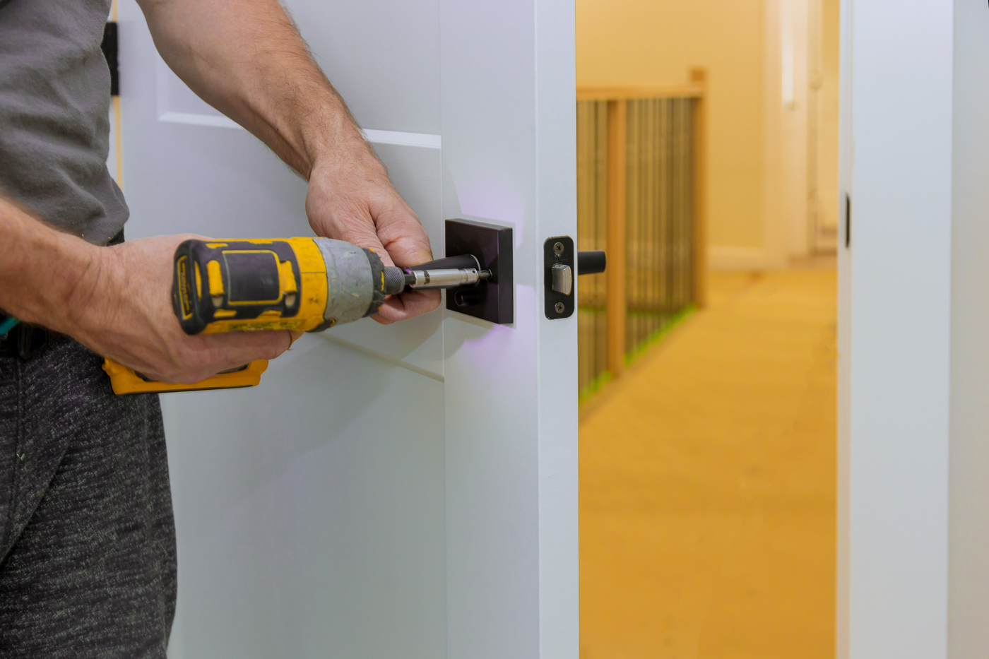 Locksmith installing digital door lock on Canadian home