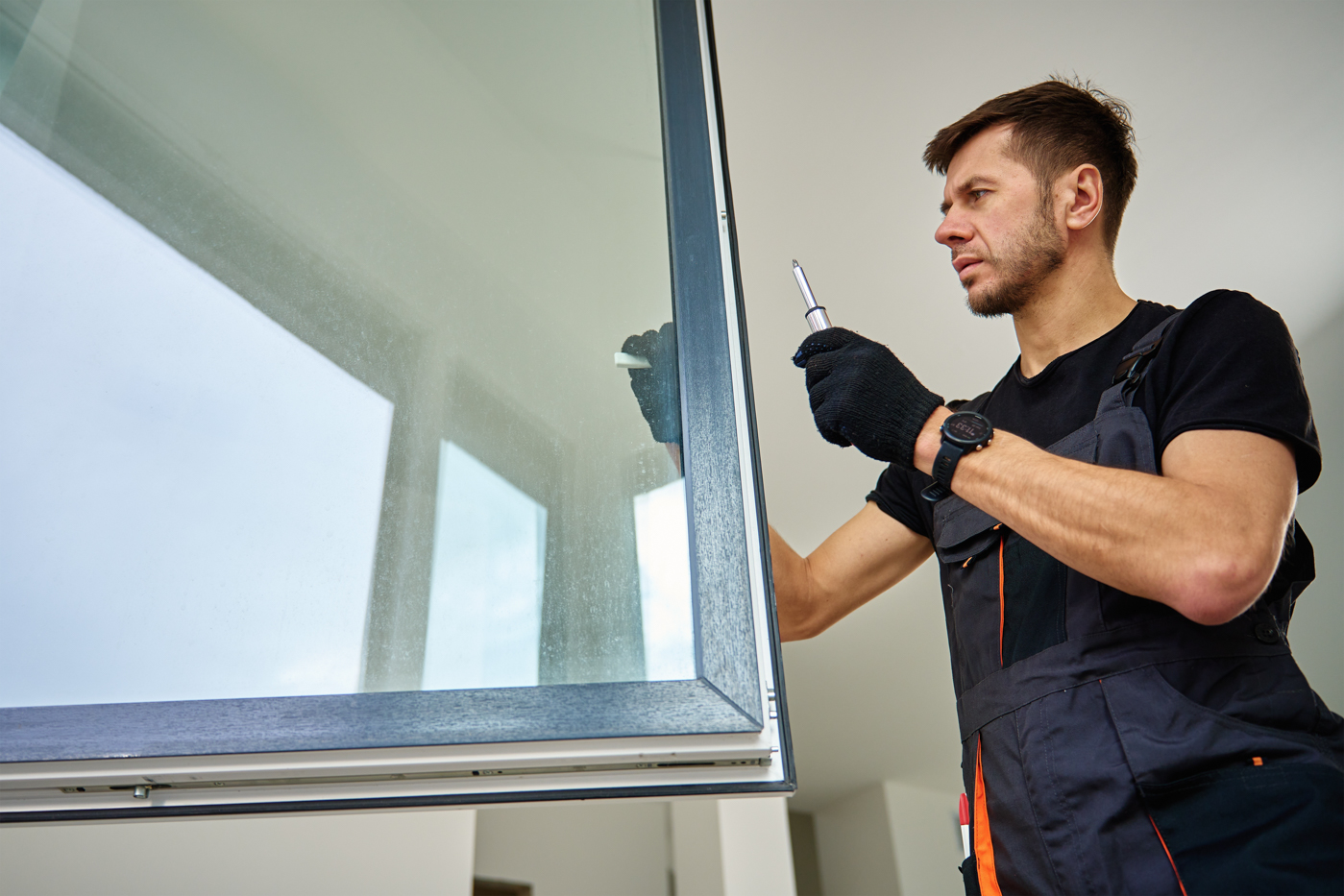 Technician holding double pane window frame in factory
