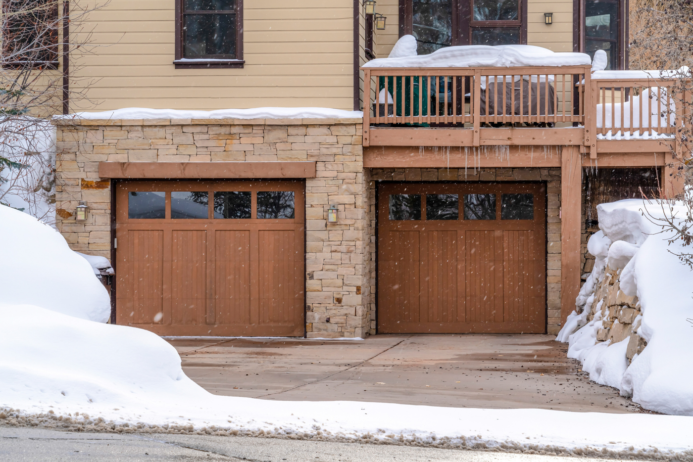 Modern black garage door on Canadian home exterior