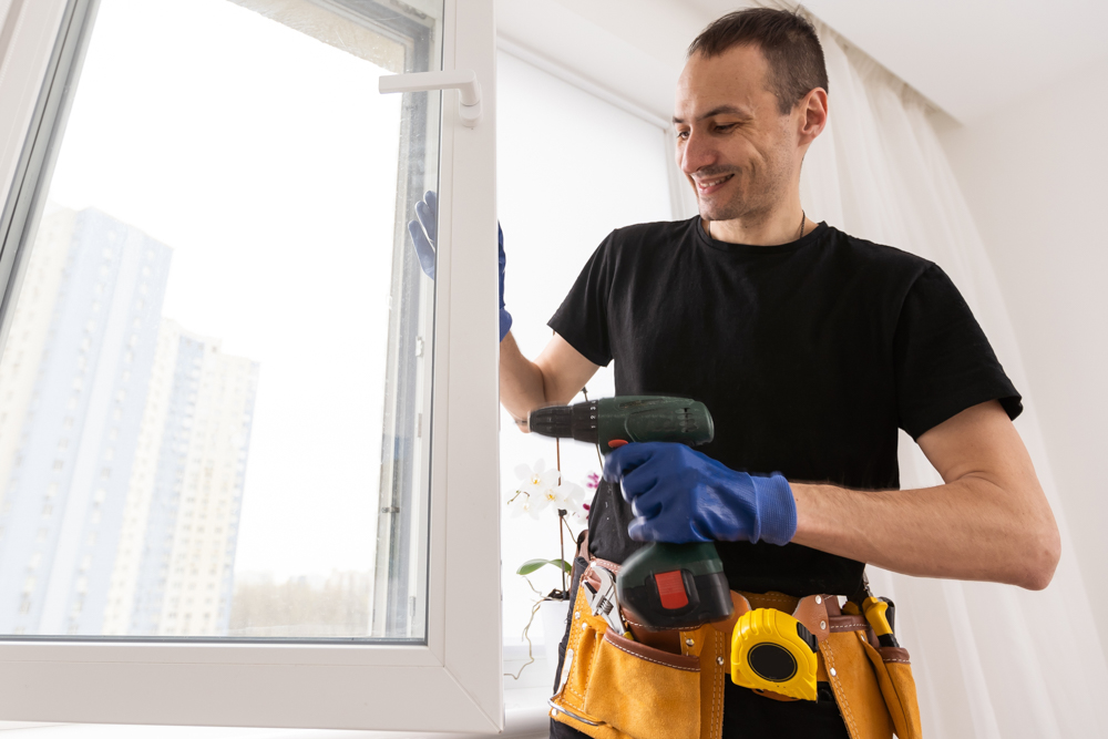 Technician maintaining window in Canadian home