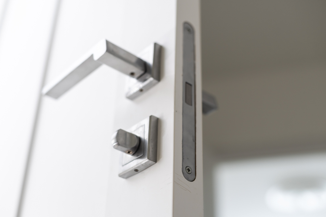Locksmith installing door lock
