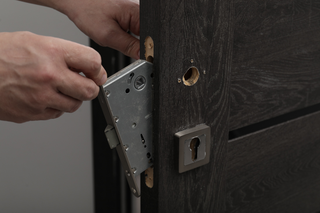 Locksmith repairing door lock