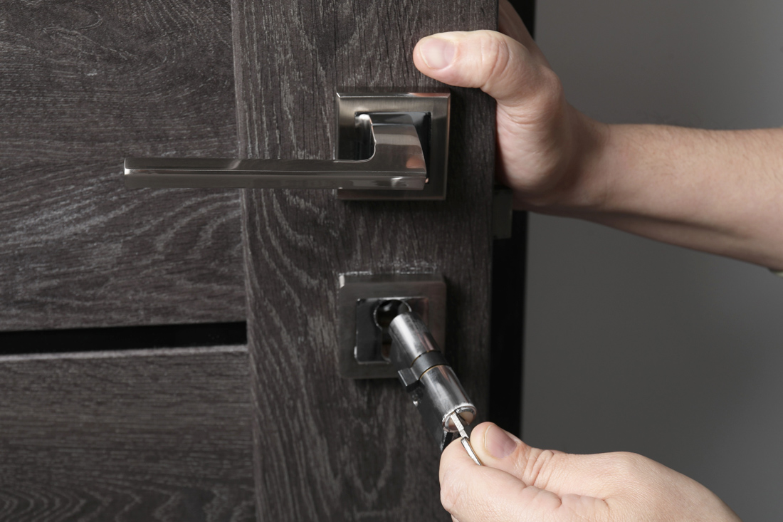 Locksmith upgrading glass door lock