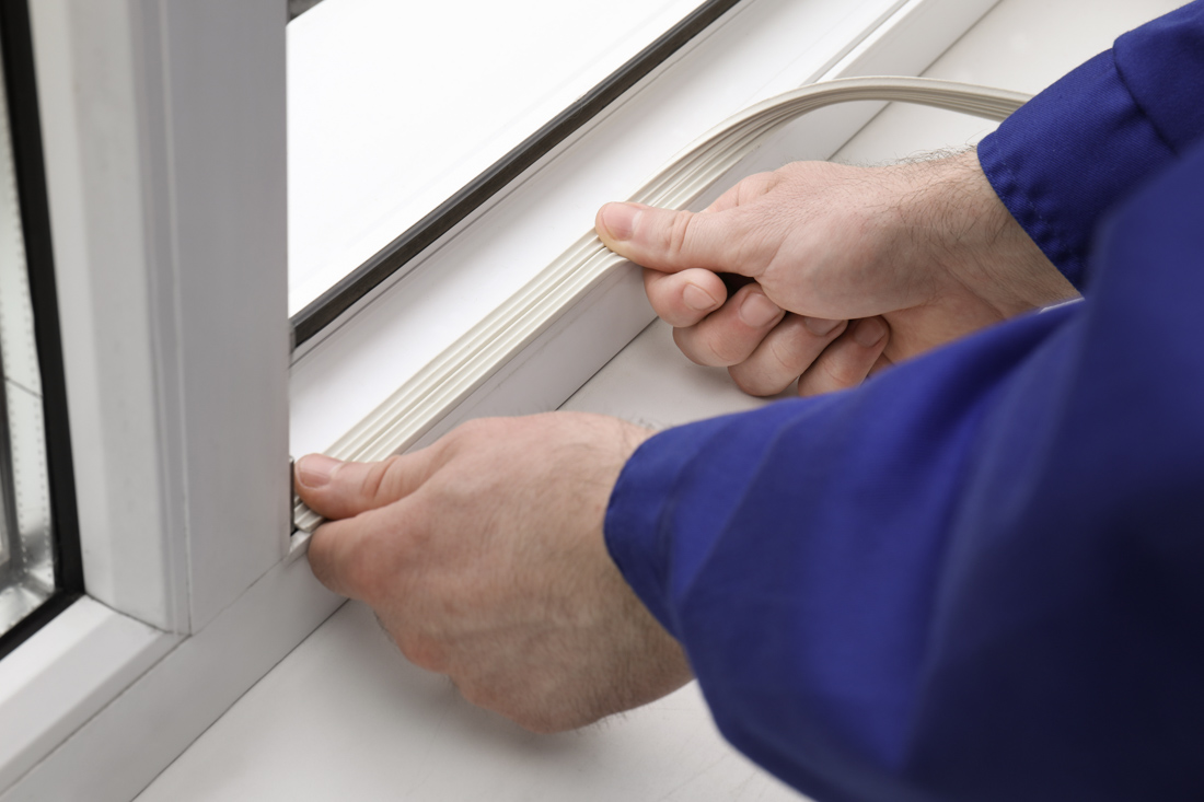 Technician installing casement window