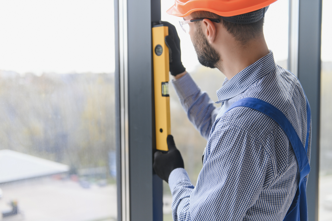 Technician measuring window for installation