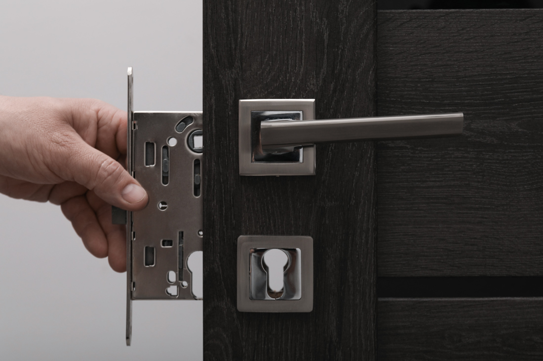 Locksmith adjusting door handle lock