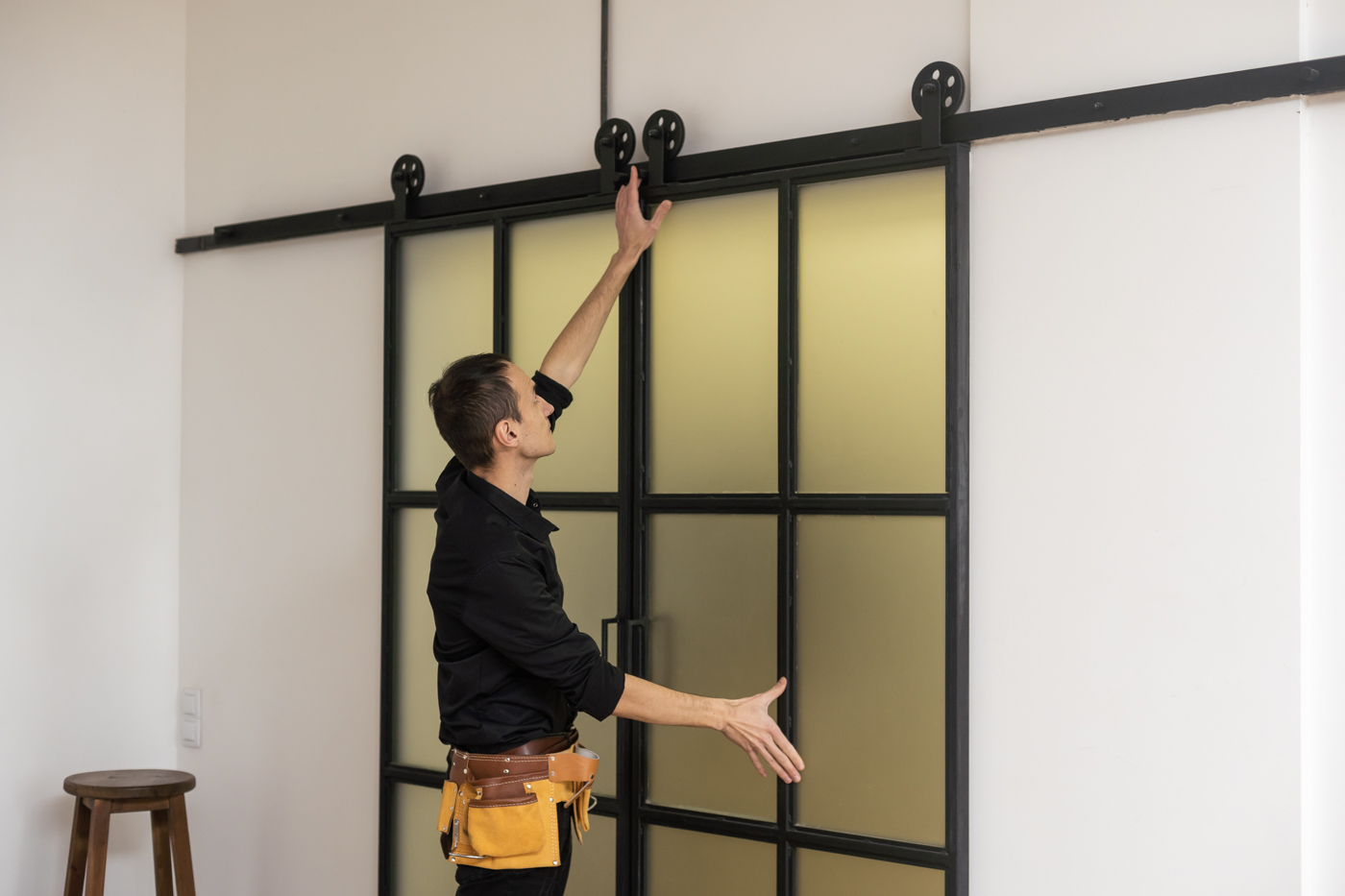 Technician installing modern sliding door