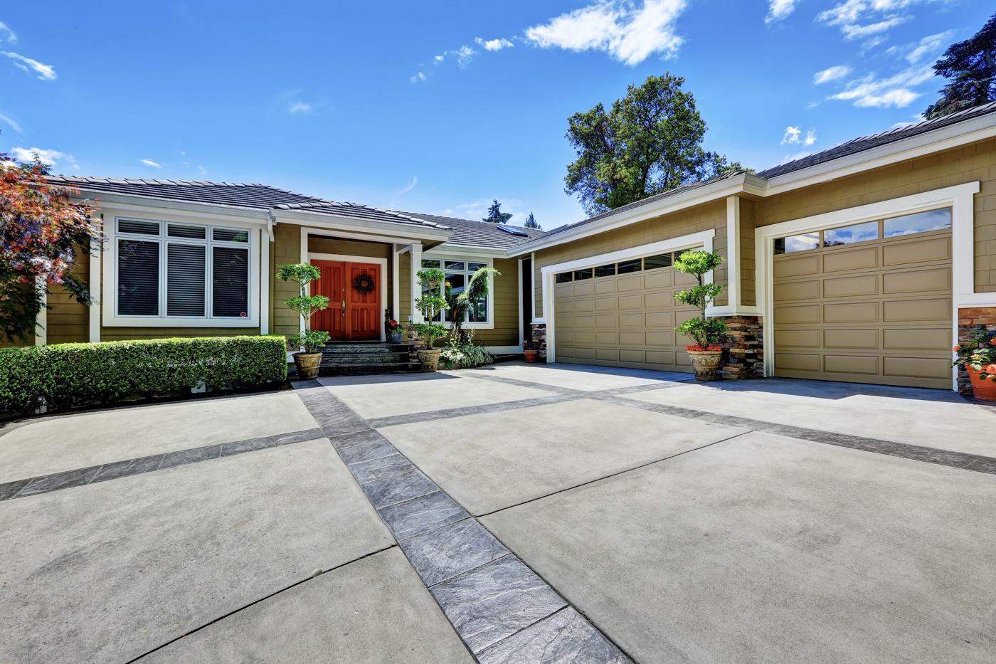 Beige garage doors with window inserts on home
