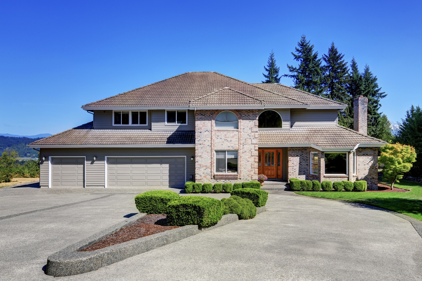 Residential garage doors on large brick home
