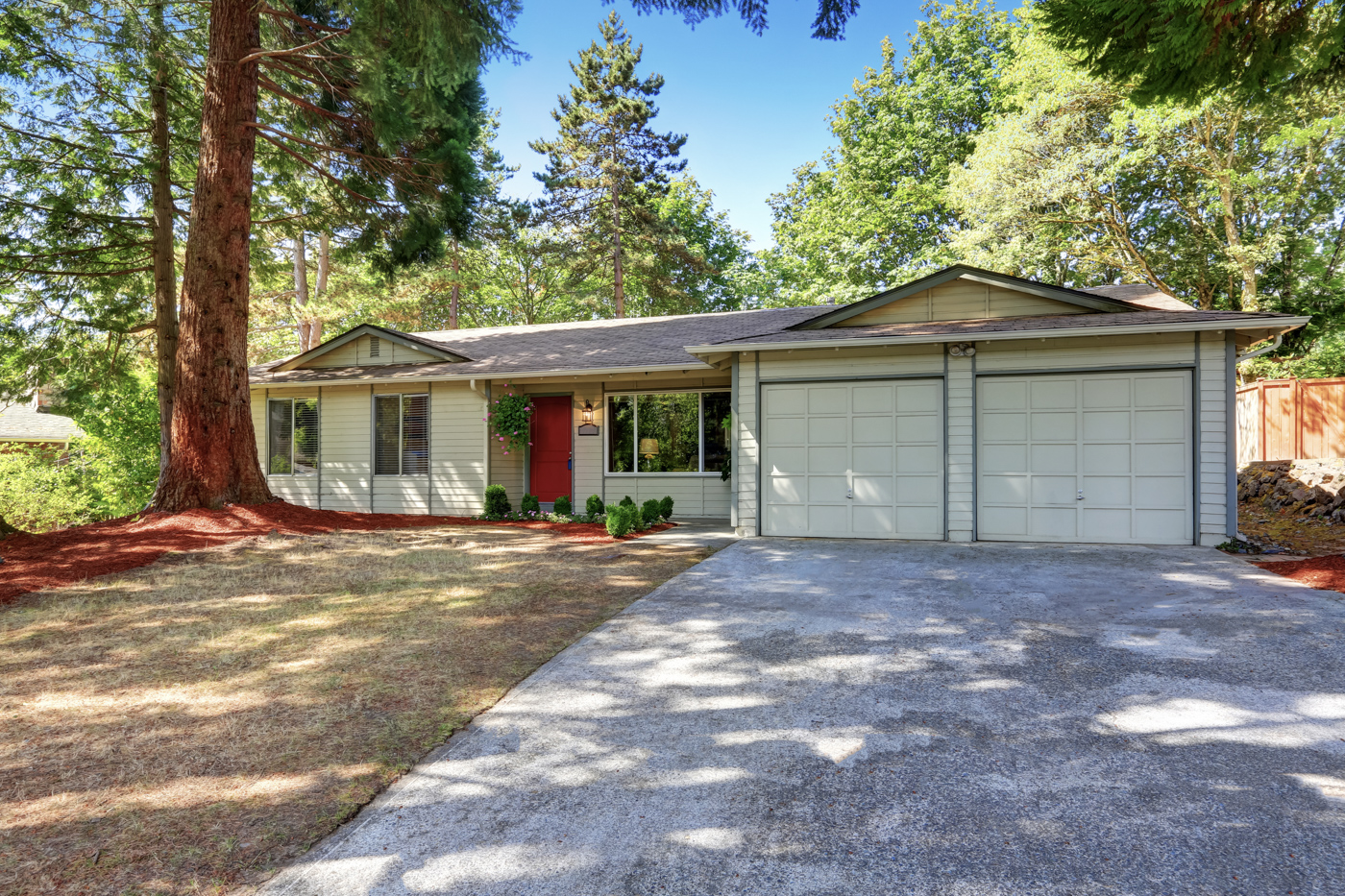 Two residential garage doors on a home driveway